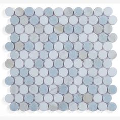 a white and blue mosaic tile with circles on the back ground, in various sizes