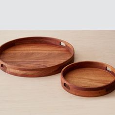 two wooden trays sitting on top of a table