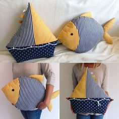 a woman is holding a pillow made to look like a fish