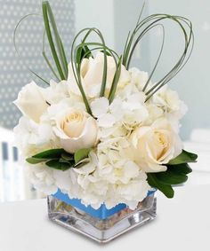 there is a vase with white flowers in it