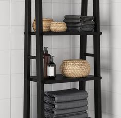 a bathroom shelf with towels and soaps on it