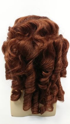 "Colonial style wig featuring waves and ringlets in all the right places, perfect for completing your 1700s look! Color: Bright Auburn (130) Style: Curly Circumference: Adjustable Straps 21\"-22\" All sales are final. Please read all store policies before purchasing." 1800s Curls, Alburn Hair Wig, Powdered Wigs 18th Century, Hamilton Cosplay, Colonial Wigs, Auburn Wig, Colonial Costume, Back Combing, Style Wig