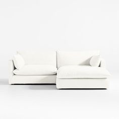 a white couch sitting on top of a white floor