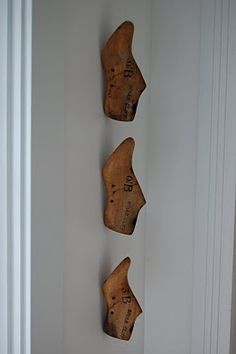 three pieces of wood are hanging on the wall