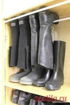 several pairs of boots are lined up on a shelf