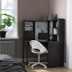 a white chair sitting in front of a computer desk