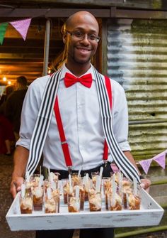 a man holding a tray full of food