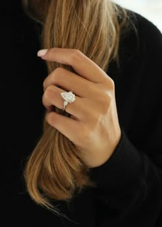 a woman's hand with a ring on her finger