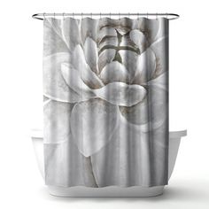 a shower curtain with a white flower on it