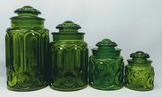 green glass jars and canisters are lined up