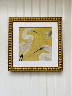 a white bird is hanging on the wall next to a yellow and white striped wall