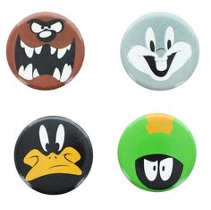 four buttons with cartoon faces on them