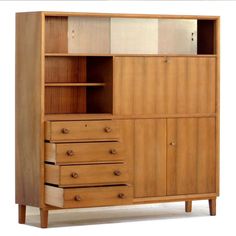 a large wooden cabinet with drawers and doors