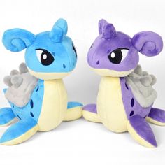 two stuffed animals sitting next to each other