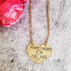 "Celebrate your friendship with this funny jewelry set for two! These are TWO beautiful broken heart necklaces hand-stamped as one with the phrase, \"PARTNERS IN CRIME\" in uppercase or lowercase font of your choice. When the necklaces are apart, the message on the full necklace isn't clear -- which is great for those of us who love to laugh at ourselves. Show your appreciation for your ride or die, partner in crime! This pair of accessories is a fantastic gift for your best friend for their bir Couples' Heart Charm Jewelry For Gifts, Couples Jewelry With Heart Charm For Gift, Heart Charm Jewelry For Couples, Couples Style Jewelry With Heart Charm For Gift, Couples' Heart Charm Jewelry For Valentine's Day, Personalized Couples Necklaces For Mother's Day, Valentine's Day Couples Jewelry With Heart Charm, Couples' Valentine's Day Jewelry With Heart Charm, Valentine's Day Jewelry With Heart Charm