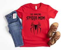 the amazing spider - man t - shirt is on display next to jeans and sandals