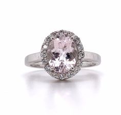 14k White Gold Oval Morganite And White Round Diamond  Ring 3.5 Grams Size 7.25 Round White Brilliant Cut Diamonds 0.2 Carats Total Weight Clarity: SI2-I1H-I 1 Oval Cut Morganite 9.5x6mm This is a stunning 14k white gold morganite and diamond ring. The morganite in this ring has a light pale color. If you have any questions or concerns please message me and I will get back to you as soon as possible. serial number: AJ051254 A Classic Oval Morganite Diamond Ring, Classic Oval Gemstones With Halo Setting, Oval Yellow Gold Gemstones With Halo Setting, White Gold Oval Gemstones Fine Jewelry, Classic Oval Gemstone With Center Stone, Oval Brilliant Cut Gemstones For Fine Jewelry, Oval White Gold Gemstones With Halo Setting, Oval White Gold Gemstones For Formal Occasions, Formal Morganite Rings With Halo Design