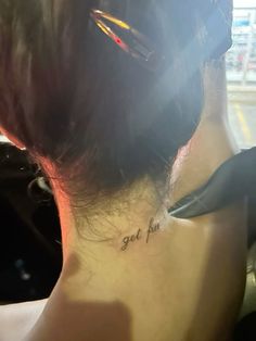 the back of a woman's neck with an inscription on it that says get her