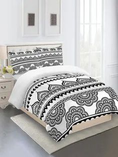 an image of a bedroom setting with white and black bedding