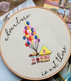 an embroidered hoop with the words adventure is out there on it and balloons in the air