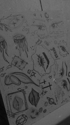 some drawings on the side of a refrigerator door with magnets and symbols drawn on it