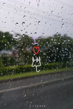 rain drops on the window with an i love sign