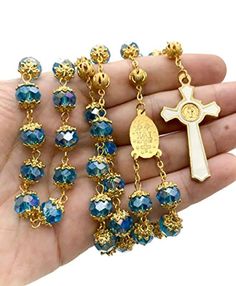 Light Blue Crystal Beads Rosary Handcrafted St. Benedict Rosary with blue crystallized glass beads with Miraculous medal and silver 1.6" Cross. Strong and elegant Rosary made of zinc alloy plated in gold for enhanced durability and corrosion resistance. ensures sturdiness while adding a touch of elegance to the design. Five decades rosary connected to devout 59 beads perfectly designed to hold on during daily usage. wearable for most people, easy to carry in your pocket, bag, or keep in your car Blue Crystal Round Bead Jewelry, Blue Crystal Round Beads Jewelry, Blue Crystal Round Beaded Jewelry, Blue Crystal Jewelry With Faceted Beads, Gold Metal Jewelry With Faceted Beads, Blue Beaded Metal Jewelry, Blue Crystal Jewelry With Polished Beads, Blue Metal Jewelry With Faceted Beads, Blue 8mm Bead Jewelry For Gift