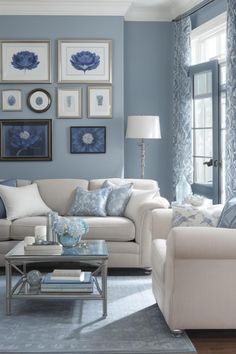 a living room filled with furniture and pictures on the wall above it's windows