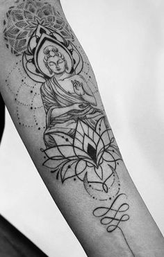 a woman's arm with a tattoo on it that has an image of a buddha