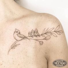 a small bird on a branch tattoo on the chest