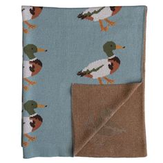 a blue and brown blanket with ducks on it