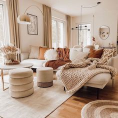 a living room filled with furniture and lots of windows