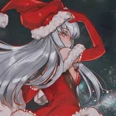 a woman dressed as santa claus with long white hair and grey hair wearing a red hat