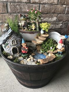 a potted planter filled with gnomes and plants