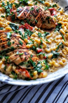 a bowl filled with pasta and chicken on top of a table