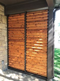 a large wooden sliding door on the side of a building