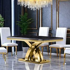 a dining room table with white chairs and a chandelier