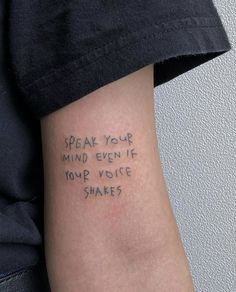 someone with a tattoo on their arm that says speak your mind even if you voice shakes