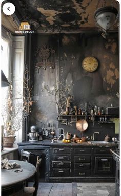 an old fashioned kitchen is decorated in black and gold