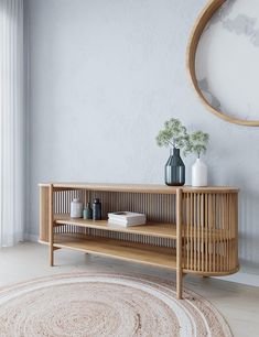 a wooden shelf sitting on top of a rug in front of a wall mounted mirror