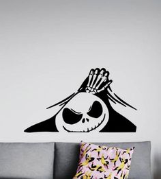 a living room with a couch and a wall sticker that has a skeleton on it