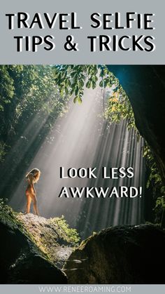 a woman standing on top of a rock in the middle of a forest with sunbeams