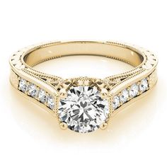 a yellow gold engagement ring with diamonds on the sides and a center stone in the middle