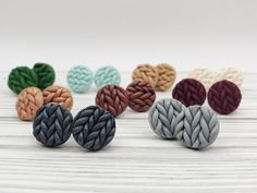 several different colored braided buttons sitting on top of a white table