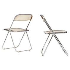 two folding chairs sitting next to each other