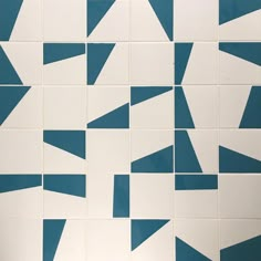 a blue and white tiled wall with different shapes