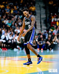 a basketball player walking on the court with his foot in the air and people watching