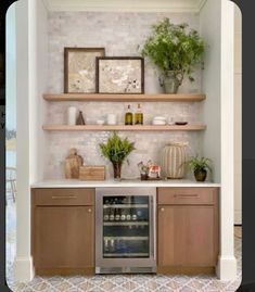 a kitchen with open shelving and plants on the shelves