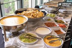 a buffet table filled with different types of food and condiments on it's sides