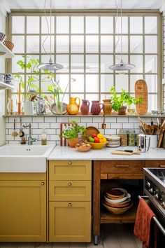 a kitchen filled with lots of pots and pans next to a stove top oven